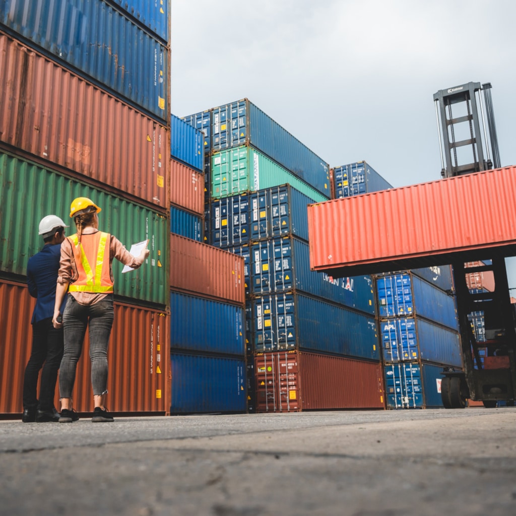 logistic worker teamwork and partner of foreman, engineer, and businessman working in an international shipping area, concept of business industrial and working in container yard to import and export